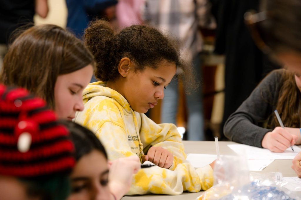 two lower grades female students doing work at their desks