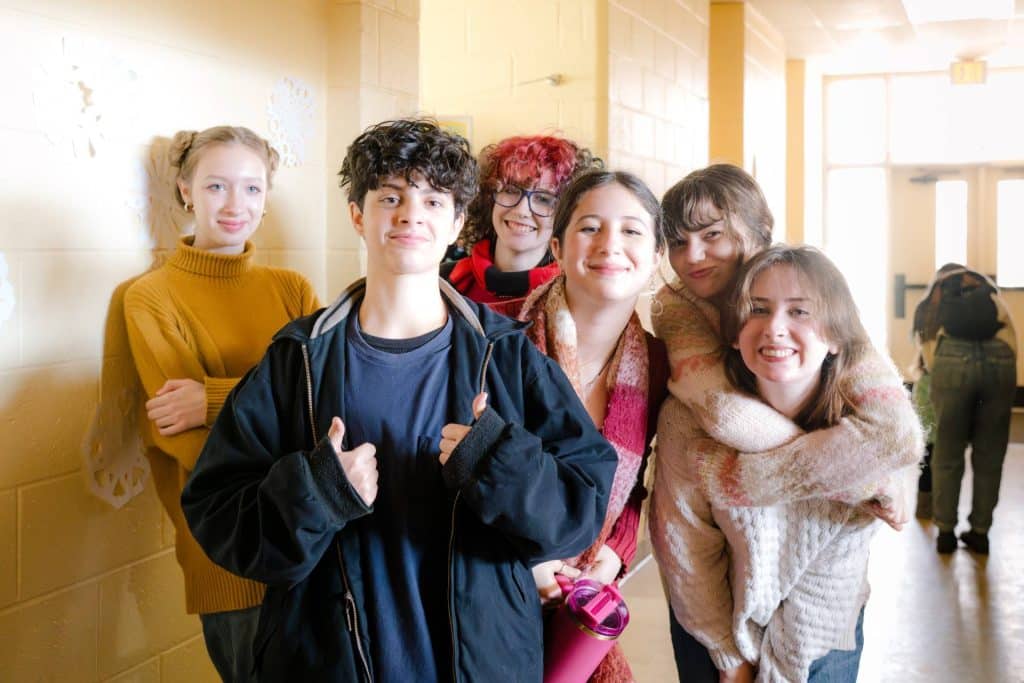 group of smiling happy middle school students