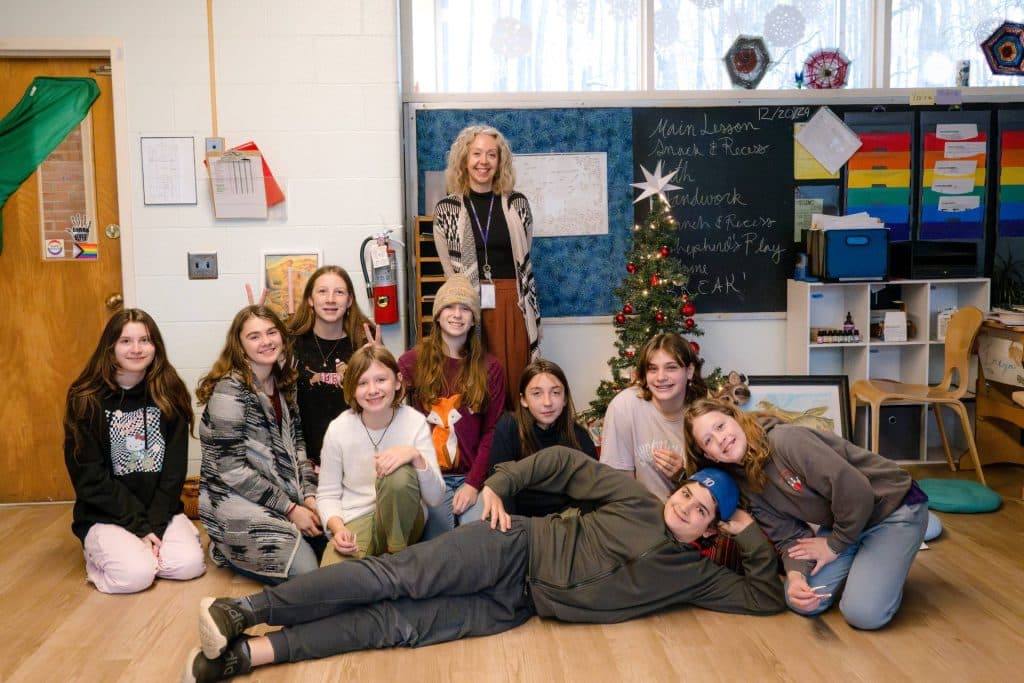 class of 7th graders smiling together during holiday party