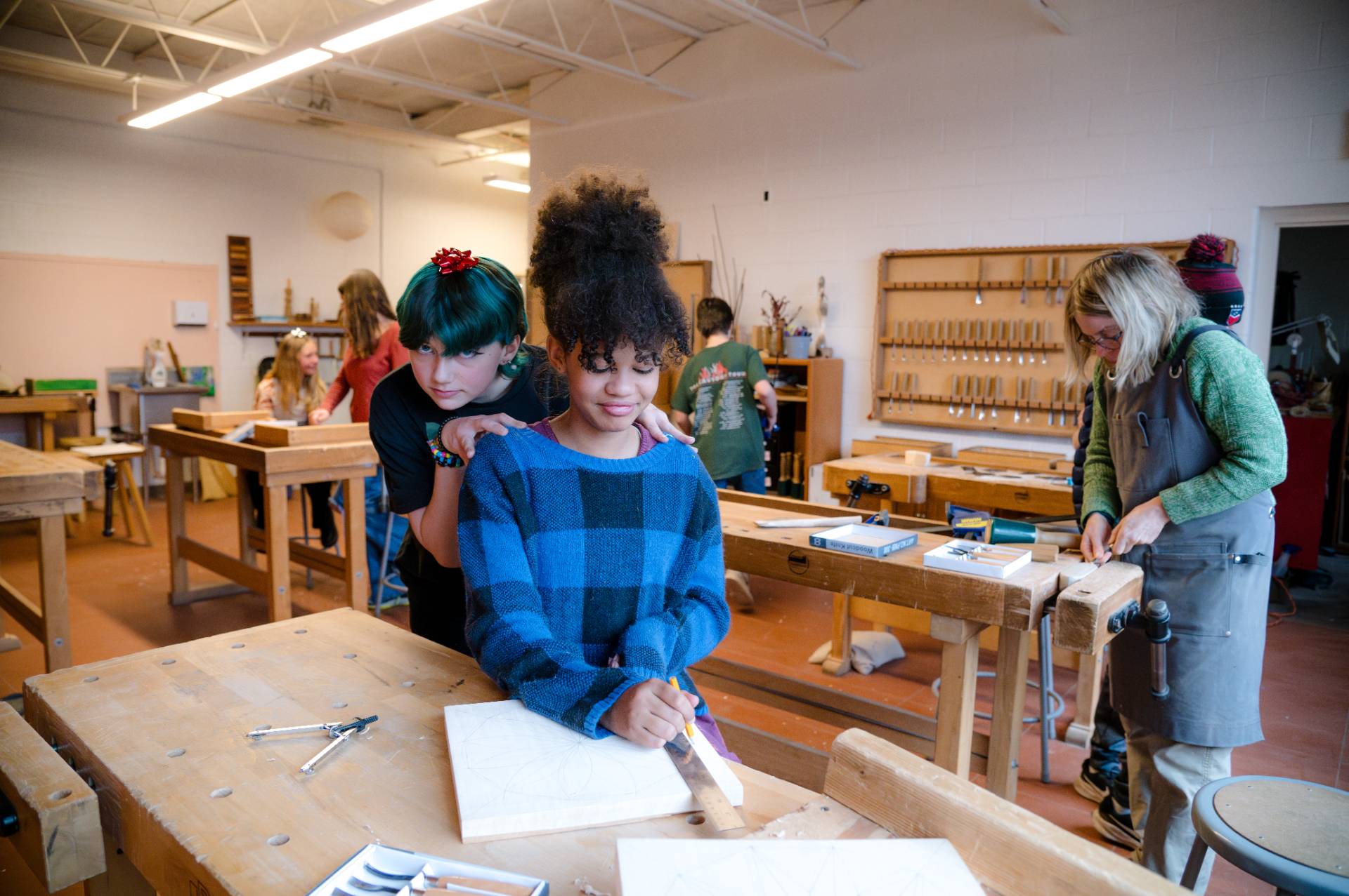 female middle school students in woodworking workshop