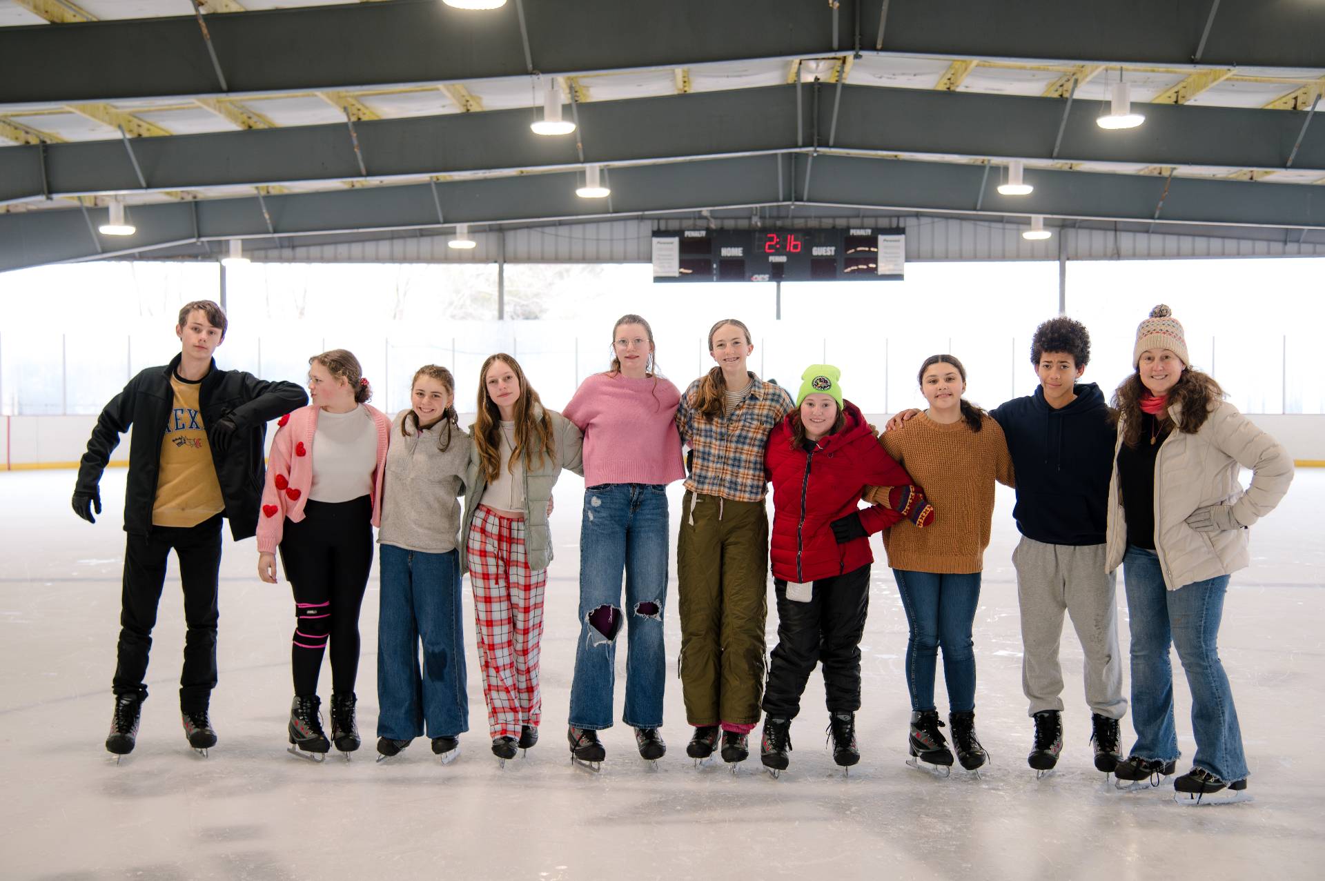 group of middle school students ice skating together on class trip