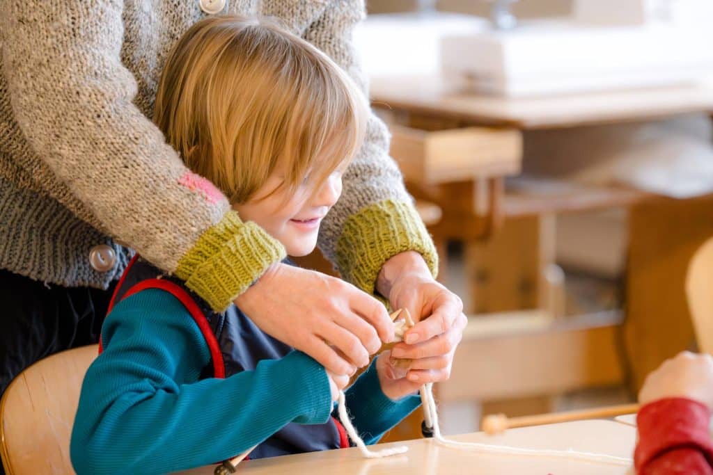 young boy doing hand crafts