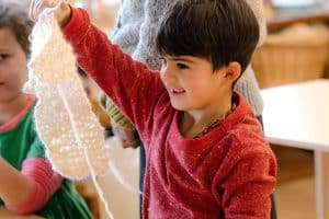 young early childhood boy doing crafts