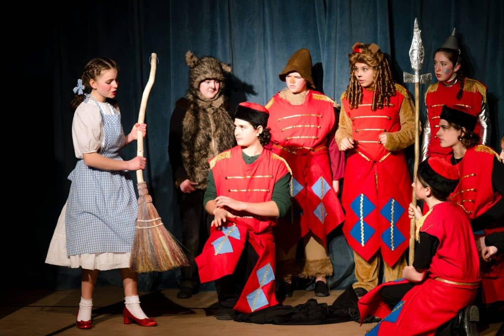 a play of the wizard of oz with dorothy on the left