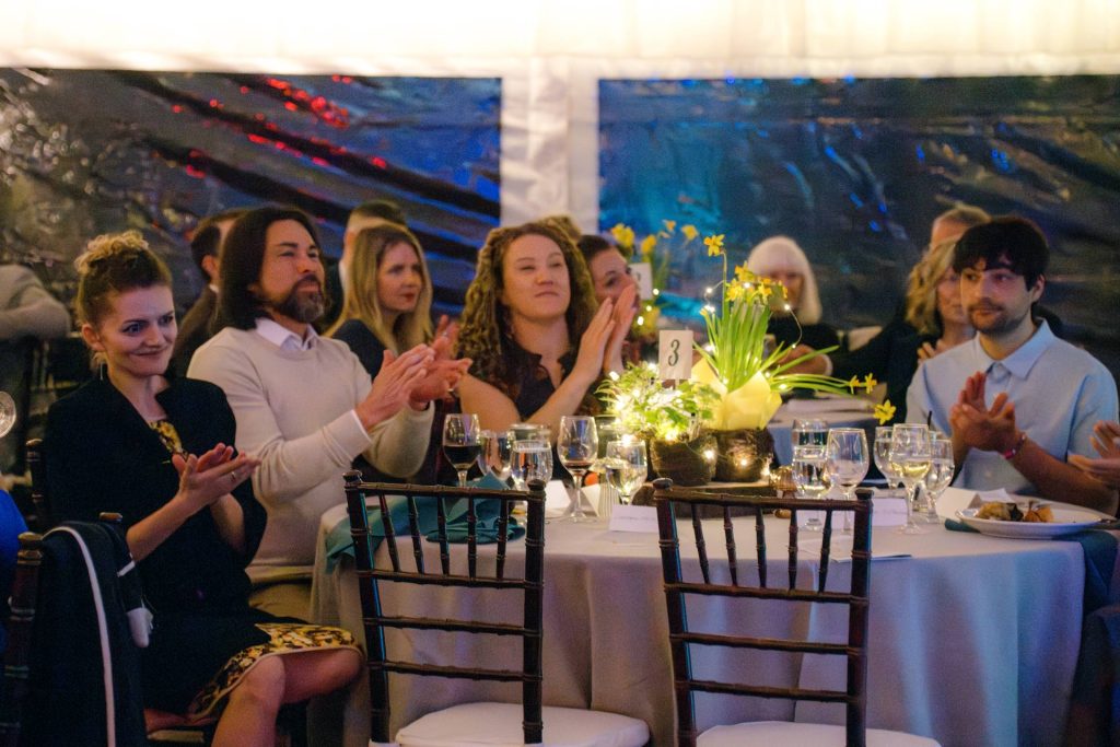 group of parents sitting at tables during annual auction event