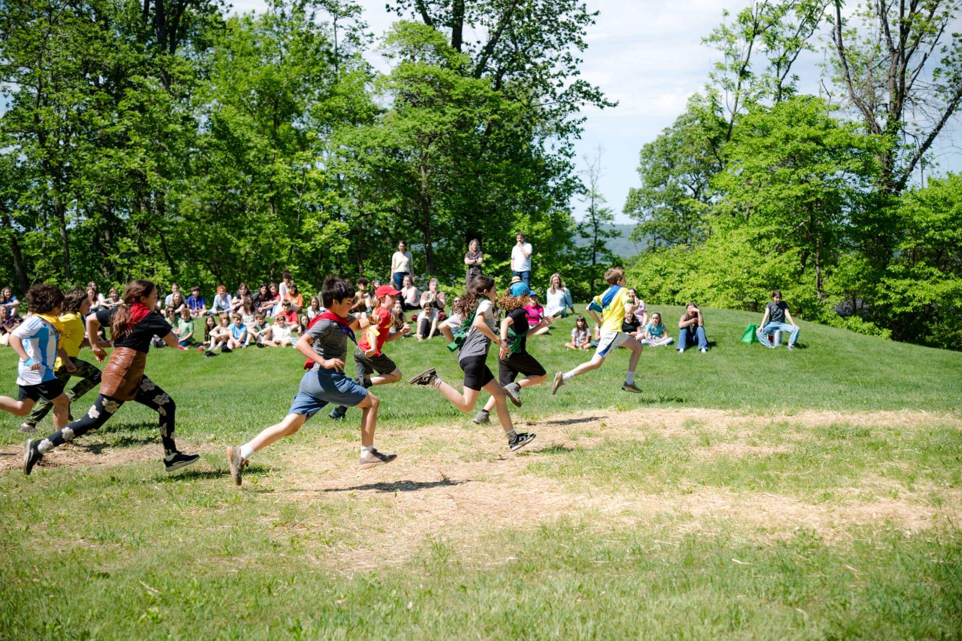students running across an open field on field day