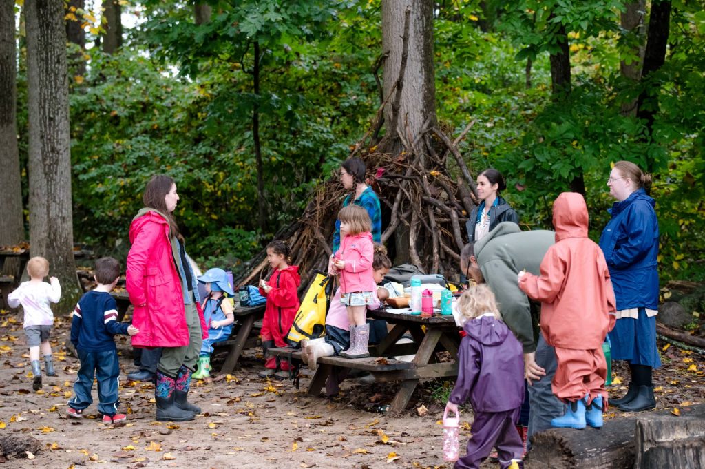 early childhood class out in nature wearing raincoats