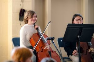 group of students playing string instruments