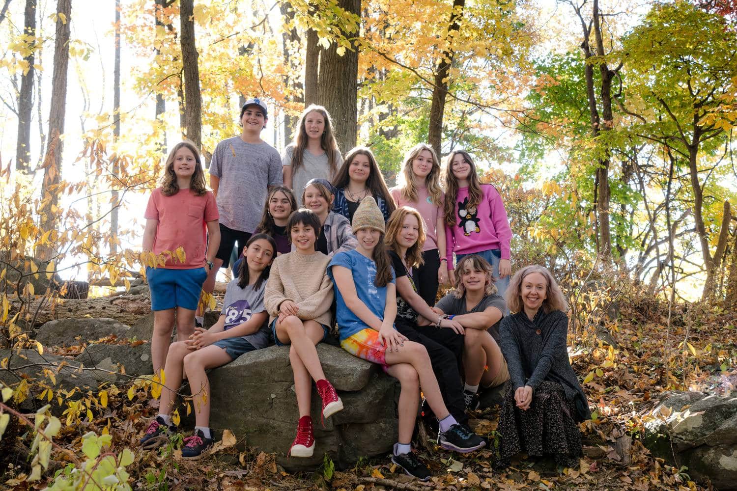 group of river valley students together in a fall forest
