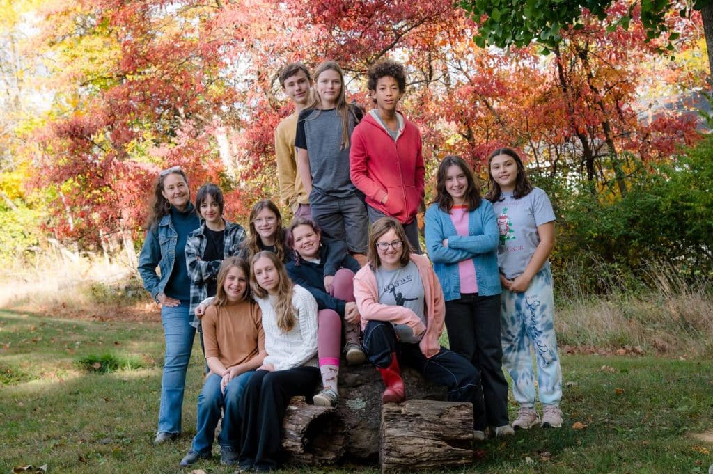 8th grade class posing together outside on a fall day