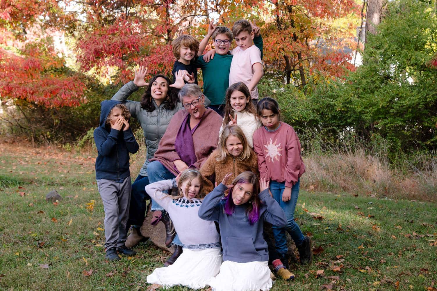 2nd and 3rd grade class outdoors in the fall taking a silly group photo