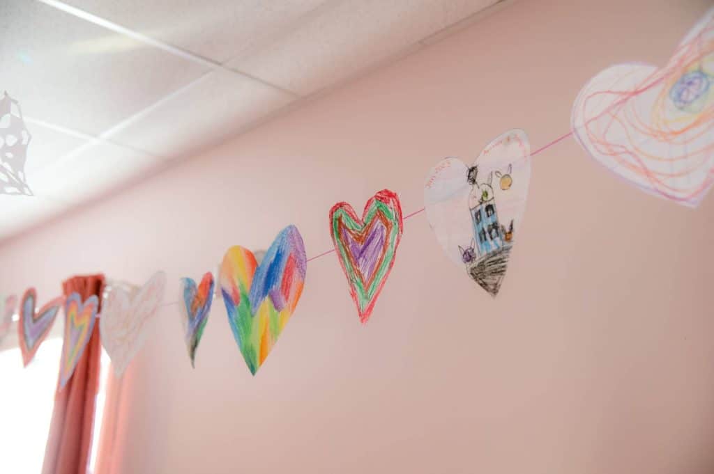 student drawings hanging on a line