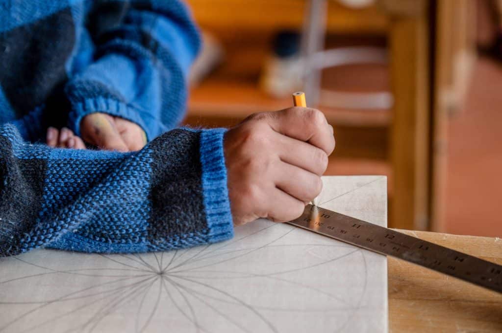 closeup of female student's hand while drawing on a piece of paper