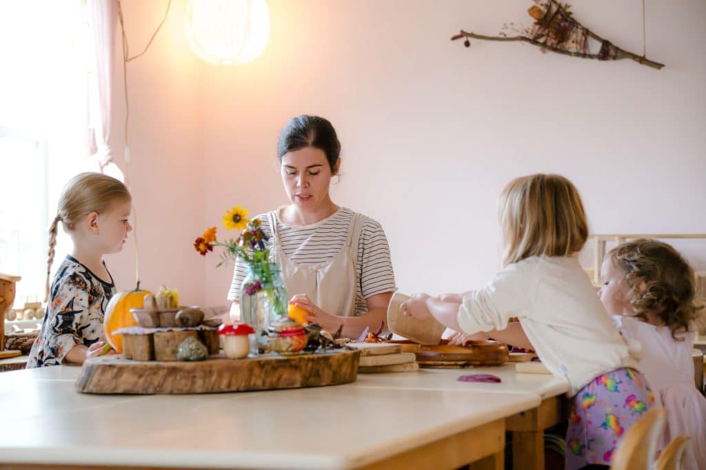 group of early childhood students at a table with their teacher
