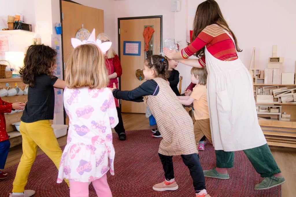 children engage in free play, circle time, listen to stories, and meaningful work such as bread baking, watercolor painting, and seasonal crafts.
