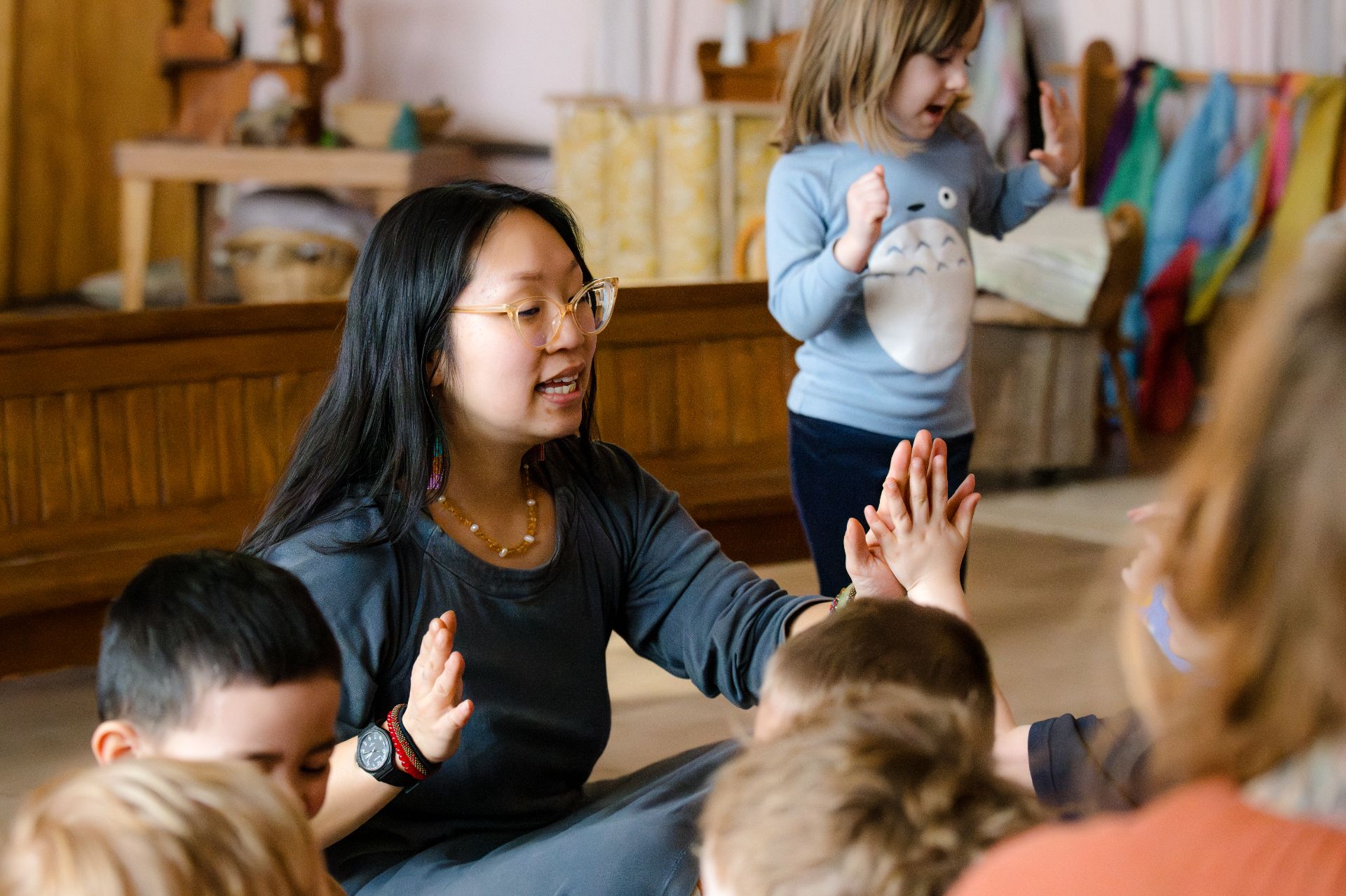 early childhood teacher playing games with students