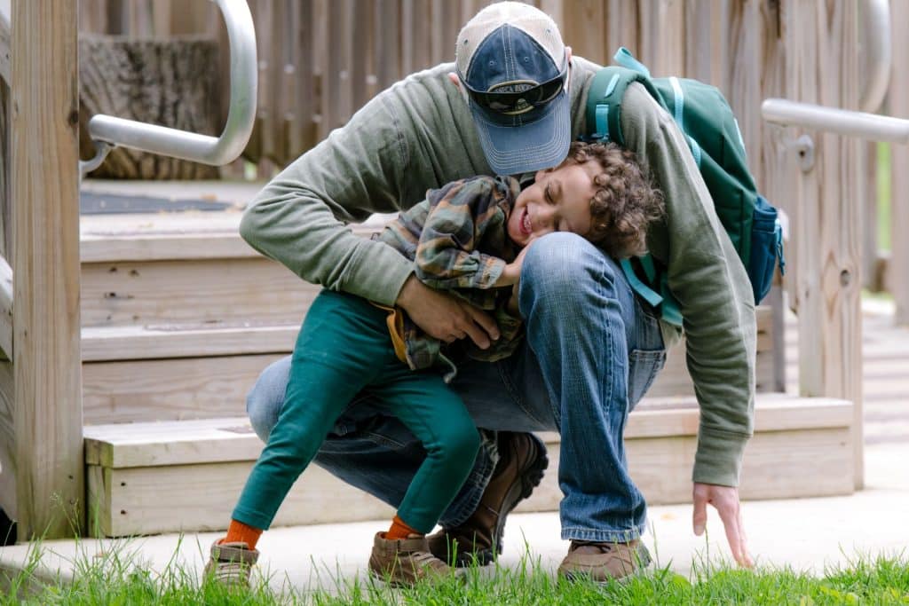 early childhood boy student playing with his dad
