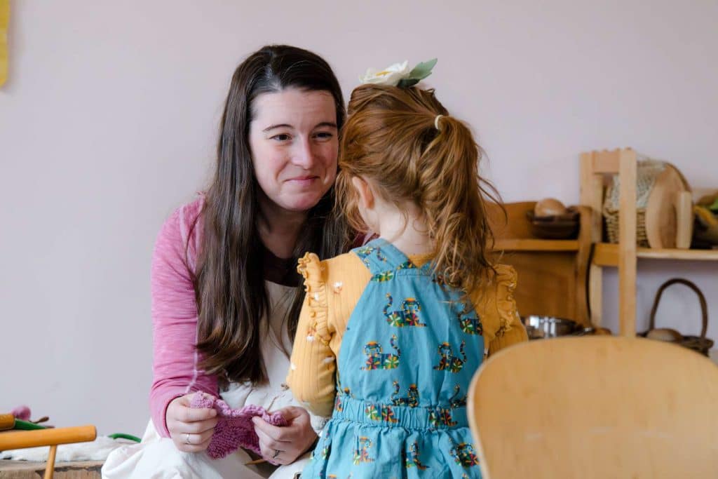 teacher talking with early childhood student