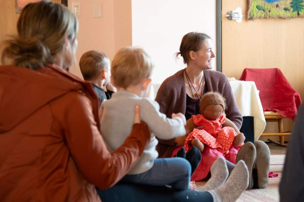 two early childhood teachers with group of students