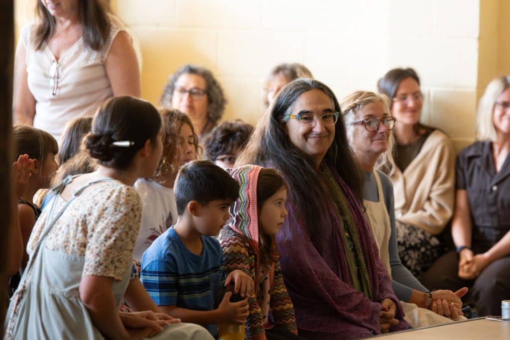 group of middle school students in white clothes with flower crowns
