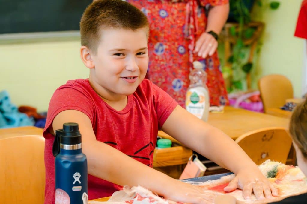 lower school boy student at his desk doing crafts