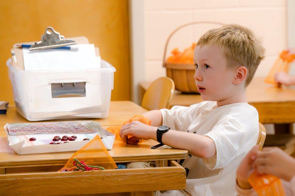 first grade students holding hands and running in a circle